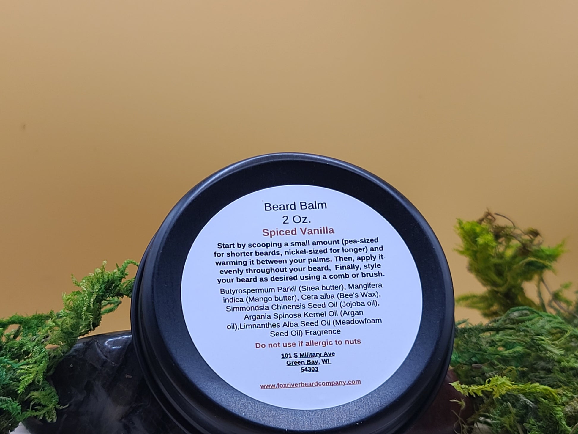 Beard balm container with label on a natural background
