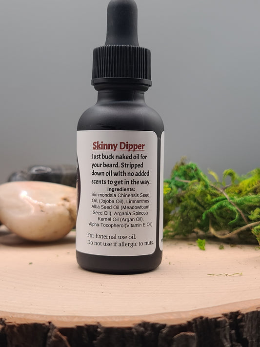 Bottle of 'Skinny Dipper' natural hair care product on a wooden surface with a blurred background