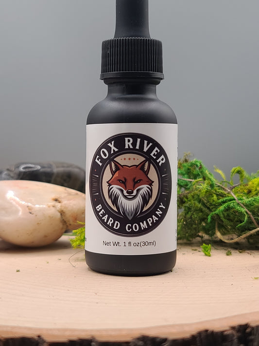 Bottle of Fox River Beard Company product on a wooden surface with natural elements.