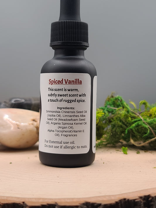 Spiced Vanilla essential oil bottle with dropper on a wooden surface