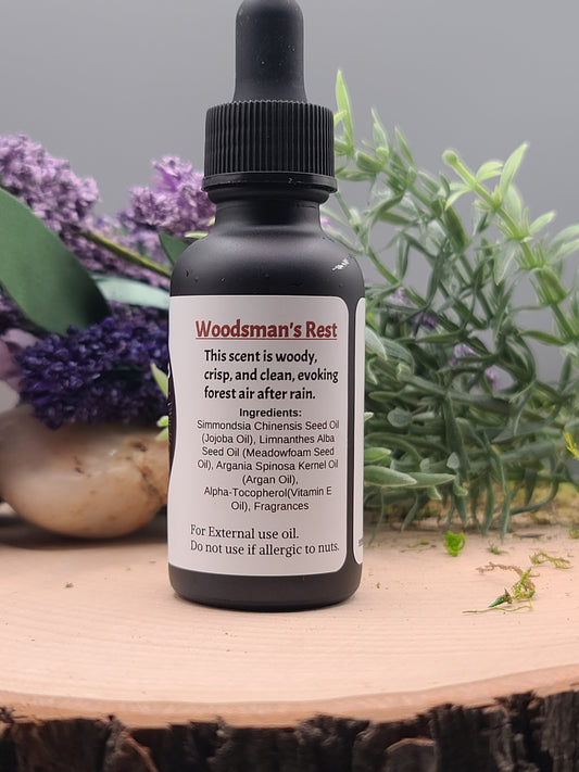 Bottle of Woodman's rest essential oil with lavender flowers and a wooden surface in the background