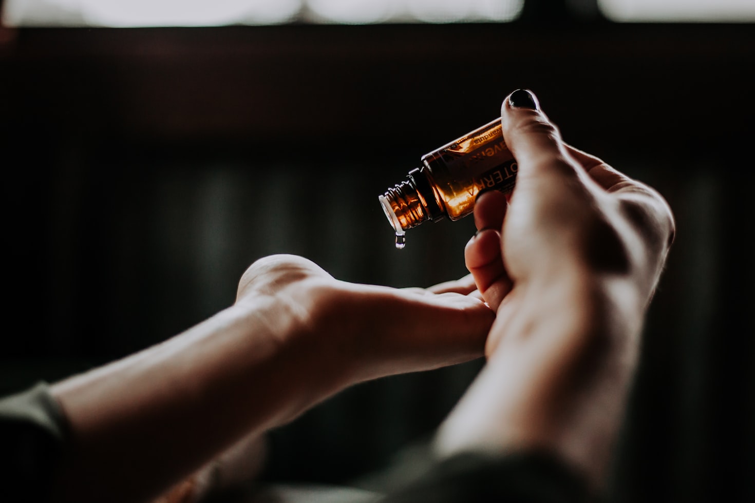 Beard oil being poured into open hand