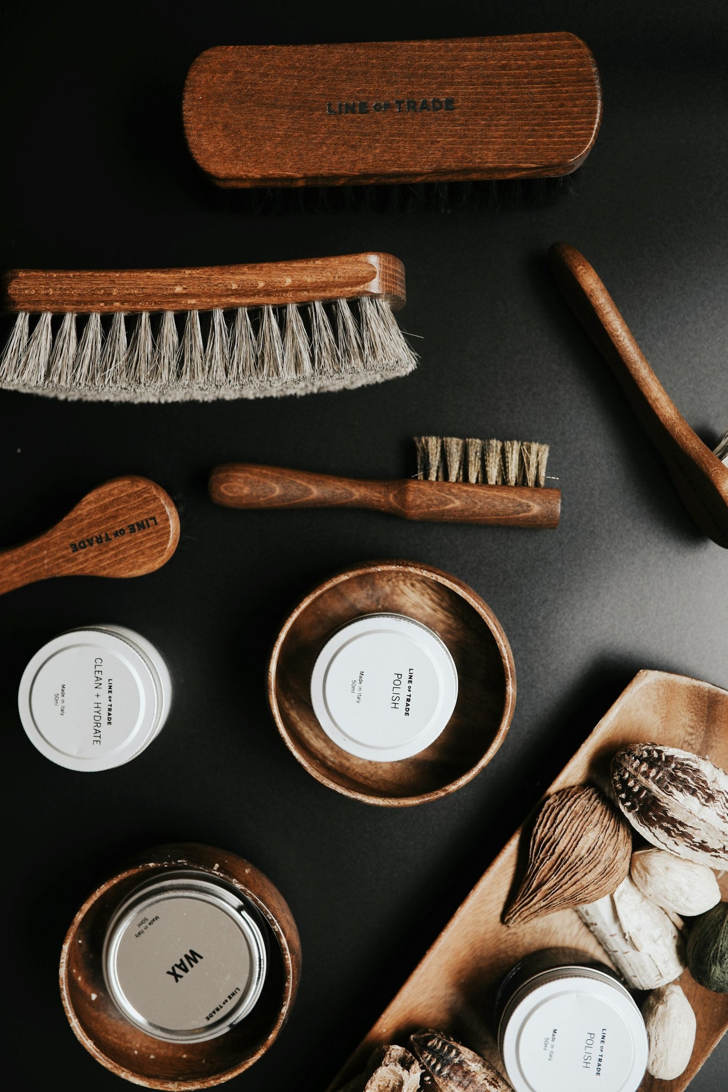 Multiple beard tools and gear laying on a black surface